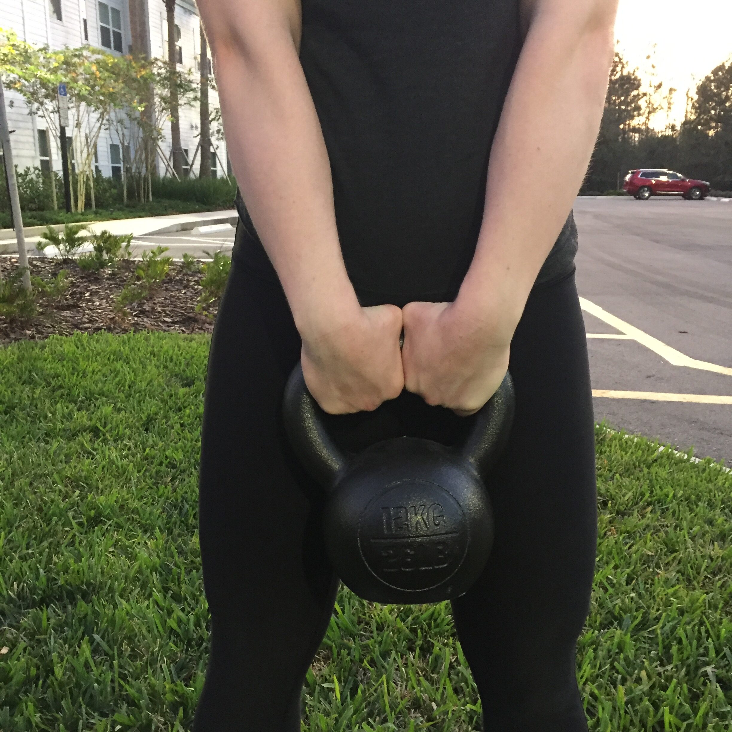 Person incorrectly overgripping a kettlebell 